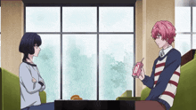 two anime characters are sitting in front of a window and one of them is holding a pink box