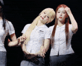two girls in school uniforms are posing for a picture with ld written on the bottom right