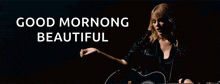 a woman is singing into a microphone while holding a guitar in front of a black background that says good morning beautiful
