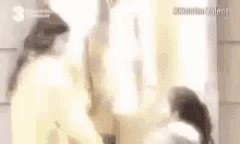 a woman is standing in front of a mirror looking at herself in the mirror .