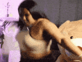 a woman is standing next to a large teddy bear