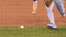 a baseball player is holding a ball in his hand on a baseball field .