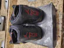 a pair of black and red air jordan shoes are sitting on top of a box