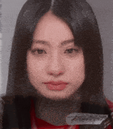 a close up of a woman 's face with a piece of paper on it that says ' a '