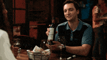a close up of a woman making a funny face with a man in the background