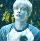 a man in a blue and white shirt is looking up