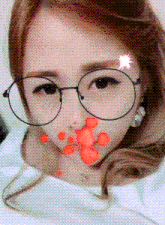 a close up of a woman wearing glasses with hearts on her face