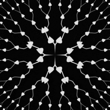 a black and white pattern with hearts and dots