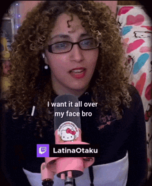 a woman with curly hair and glasses says " i want it all over my face bro " in front of a hello kitty microphone