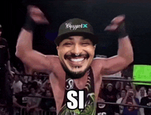 a man wearing a hat that says blizzard is smiling in a wrestling ring