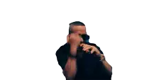 a man wearing sunglasses and a watch holds his fist to his face