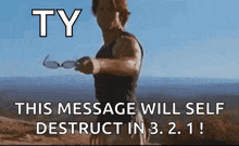 a man is holding a pair of sunglasses in front of a message that says ty this message will self destruct in 3.2.1