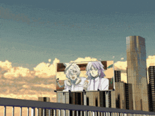 a billboard with two anime characters on it in front of a city