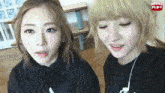 two girls are sitting next to each other in a room with a minx play logo on the bottom right