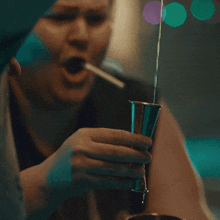 a person is pouring liquid into a glass