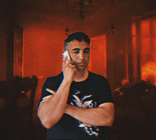 a man talking on a cell phone with a blurred background