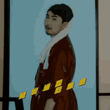 a man wearing a red robe and a white towel around his neck