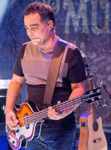 a man wearing a calvin klein shirt playing a guitar