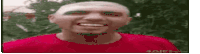 a bald man in a red shirt is smiling .