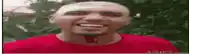 a bald man in a red shirt is smiling .