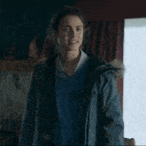 a girl wearing a sweater that says ' boston college ' on the front