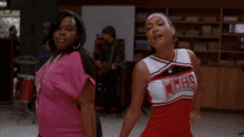a cheerleader wearing a red and white uniform with the word ncs on it