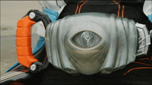 a close up of a belt with an orange handle and a silver eye