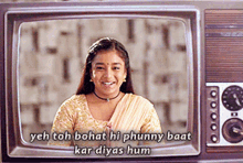 a woman is smiling in front of a television screen with the words yeh toh bohat hi phunny baat kar diyas hum below her