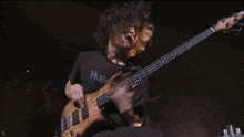 a man wearing a hurley shirt is playing a guitar