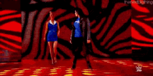 two women are standing next to each other on a stage .