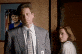 a man in a suit has a fbi badge on his jacket