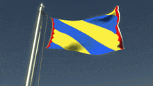 a blue yellow and red flag is waving in the wind against a blue sky
