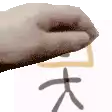 a close up of a hand holding a piece of paper with a chinese symbol on it .