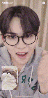 a young man wearing glasses and a grey hoodie with the word abercrombie on it
