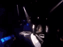 two men are shaking hands on a stage while dancing .