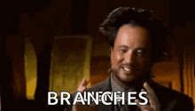 a man in a suit and tie is talking about branches .