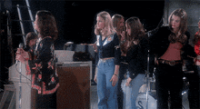 a group of women standing in front of a drum that says s on it