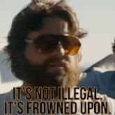 a man with a beard wearing sunglasses says it 's not illegal it 's frowned upon ..