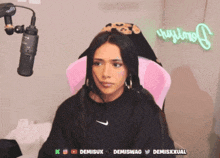 a woman sitting in front of a microphone with the name demiswag on the bottom right corner