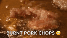 a close up of burnt pork chops being cooked in a pan