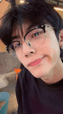 a close up of a person wearing glasses and making a funny face .