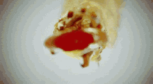 a close up of a piece of pizza with a tomato in it