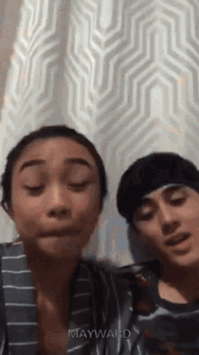 a boy and a girl are standing next to each other with their eyes closed and mayward written on the bottom