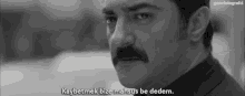 a black and white photo of a man with a mustache and the caption kaybetmek bize mahsus be dedem .
