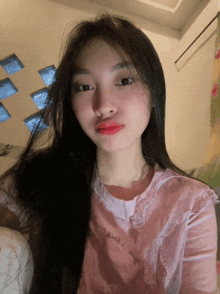 a girl with long hair wearing a pink shirt that says ' almost ' on it