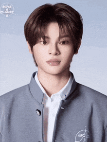 a young man wearing a boys on planet jacket