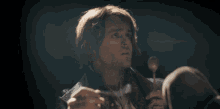 a man with red hair is holding a microphone and saying " rude "