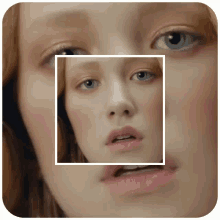 a woman 's face is shown in a square frame