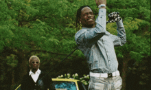 a man swinging a golf club while another man watches