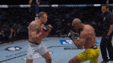 two men fighting in a boxing ring with a t mobile arena banner behind them